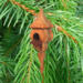 Handcrafted miniature wooden birdhouse ornament shaped like an icecicle with a pointed roof and base, featuring a rounded entrance hole and a perched bird, and made from reclaimed hardwoods finished with a satin shellac.