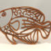 Handcrafted wooden tropical fish ornament made from 1/4-inch thick oak, finished with shellac, designed for holiday decor or year-round display as wall art.