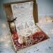 Handmade Dear Santa Letter Kit with cocoa cone, candy canes, crayons & reindeer food in festive box under soft Christmas lights. Handmade Dear Santa Letter Kit with cocoa cone, candy canes, crayons & reindeer food in festive box under soft Christmas lights.
