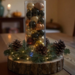 Rustic handmade centerpiece with pinecones and evergreen sprigs glowing under soft lights; artisan decor for cozy gatherings. Rustic handmade centerpiece with pinecones and evergreen sprigs glowing under soft lights; artisan decor for cozy gatherings.