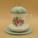 This is the pincushion bobbin holder sitting on top of the trivet, The view is from the front with the handle on the right. This is the pincushion bobbin holder sitting on top of the trivet, The view is from the front with the handle on the right.
