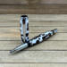 Capped rollerball pen with coffee beans in white resin  Capped rollerball pen with coffee beans in white resin