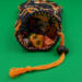 This is showing the opening of the bag with the dice inside. This is showing the opening of the bag with the dice inside.
