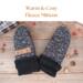 Pair of warm & cozy speckled black and white fleece baby mittens with black ribbed cuffs; thumbless winter mittens for toddlers.