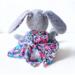 Back view of handmade rabbit doll showing floral dress details and floppy ears lined with matching cotton fabric.