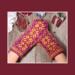 Pair of handmade purple and golden yellow wool mittens featuring Nordic-inspired knit pattern; cozy, artisan-made winter accessory.