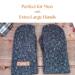 Pair of black extra large mittens displayed on rustic wood background; soft fleece winter gloves for xl large handed men.