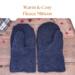 Pair of warm and cozy navy blue fleece men's mittens on rustic wood background — winter extra large mittens for men.