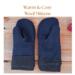 Pair of warm and cozy blue regular sized wool women's mittens on rustic wood background — winter regular size mittens for woman.