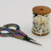 This view shows the 2 inch high wooden spool and her embellishment, The multicolored scissors are 4 inches long and included.