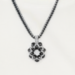 Black and white beaded pendant necklace featuring circular geometric pattern.