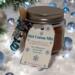 Winter Cocoa Jar on snow background with pine branches and glowing white lights for a festive look