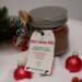 Hot Cocoa Mix Jar with red ornaments and greenery, handmade Christmas drink mix gift by Me and You Creations.