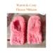 A pair of handmade coral pink mittens for kids ages 8 to 10 years old.