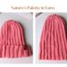 A hand knit hat featuring wool yarn in pink ribbing. Perfect for gifting, this stretchy hat suits adults and teens.