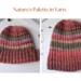 A hand knit hat with wool acrylic yarn in variegated red and purple stripes. Perfect for gifting, this stretchy hat suits adults and teens.