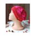 A hand knit red acrylic beanie in a textured stitch pattern. For winter holiday gifting for kids ages 6, 7, 8, 9.