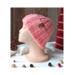 A hand knit pink wool beanie with a ribbing stretchy stitch pattern. For children and preteens ages 10, 11, 12, 13, 14.