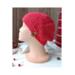 A hand knit red acrylic beanie in a textured stretchy stitch pattern. For winter holiday gifting for kids ages 10, 11, 12, 13, 14.