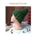A hand knit green acrylic hat styled. Rich cozy ribbed stitches provide warmth and stretch. Perfect as a holiday gift for kids ages 10 to 14