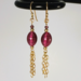 Drop earrings, 2 1/2 inches long, with ruby red color beads. Made with durable 14K GF ear wires and chain. Dainty Swarovski crystal accents.