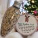 Magic Reindeer Food Ornament hanging in front of a Christmas tree with festive holiday décor
