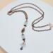 Handmade aquamarine and copper lariat necklace with vertical drop, natural gemstone beads, and a copper chain with hook clasp.