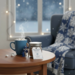 Winter Warm Up handmade hot cocoa jar on table with steaming mug by window, creating a cozy snowy winter atmosphere
