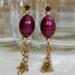 Ruby red earrings with golden cascading chain. Durable 14K gold filled metal components