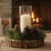 Rustic wood slice candle centerpiece with pinecones displayed near fireplace, cozy winter farmhouse decor