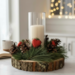 Farmhouse wood slice candle centerpiece with faux pine, pinecones, red hearts, and ivory pillar candle