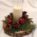 Handmade rustic wood slice candle centerpiece with pine greenery, pinecones, red heart accents, and glass hurricane candle holder