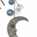 Close-up of moon pendant with crystal and star charm