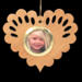 Wooden heart-shaped ornament with scalloped edges and an oak grain finish, featuring a removable round gold frame that holds a photo of a smiling blonde child.