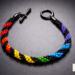 Rainbow Helix One Spectrum Pride Kumihimo bracelet by Bead & Braid Collective, handmade spiral rainbow beaded design on a dark background