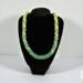 Verdant Fade Kumihimo Necklace displayed on a black bust stand, showing overall shape, proportions, and green fade pattern