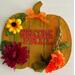 A colorful Fall pumpkin plaque.  Handcrafterd with 3 colors of paint, numberous flowers and different foliage all produce a wonderful decorative item for your Fall and Thanksgiving decor.  Plaque measures 9" x 9".  Does not come with picture stand easel.