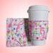 Pink ribbon caring gift set - one large mug rug / coaster and a cup cozy in pink ribbon, flowers, and words of hope pattern with a hot pink reverse.  In addition all products are reversible and support Breast cancer research.