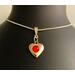 A dainty puff heart with a red crystals, silver bail, and silver plated chain.  This is  beautiful for a  young musicians birthday.  Simplistic and lovely.