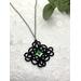 Black lace pendant with faceted green crystal